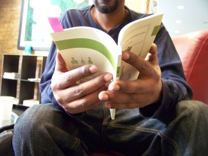 Dane Swans hands holding book